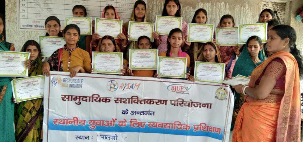 Participants display their certificates after the SPS sewing course