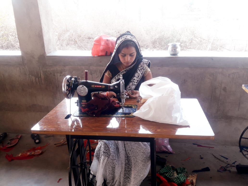 Preety practises stitching at a sewing machine