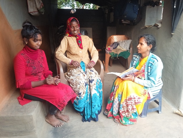 A volunteer speaks with the family during follow-up