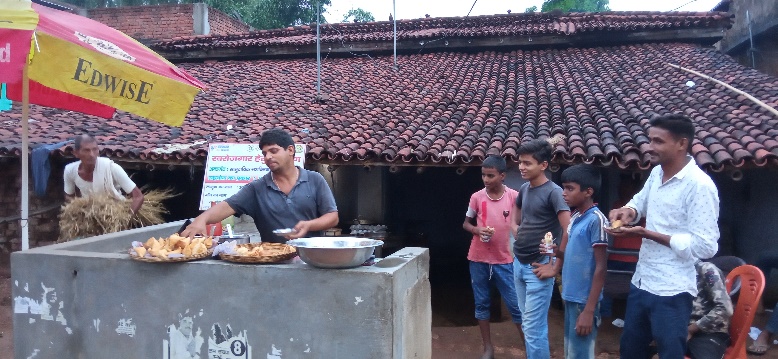 Ajay serves customers at his food stall in Khoto